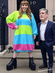 Angela Rayner standing in Parliament, her expression fierce, as Keir Starmer listens behind her with folded arms - Symbolic tension in Labour’s leadership